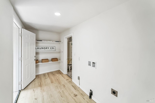 washroom with washer hookup, light hardwood / wood-style floors, and electric dryer hookup