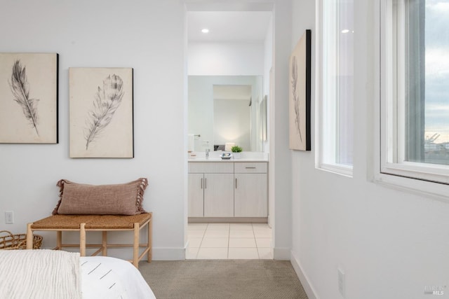 tiled bedroom featuring ensuite bath