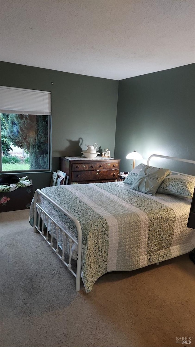 carpeted bedroom featuring a textured ceiling