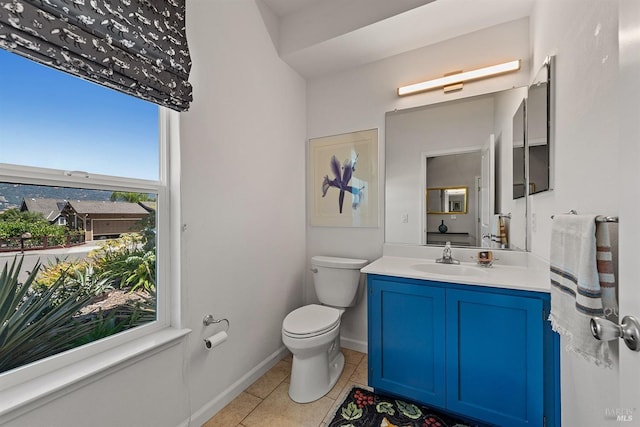 bathroom with tile patterned flooring, vanity, and toilet