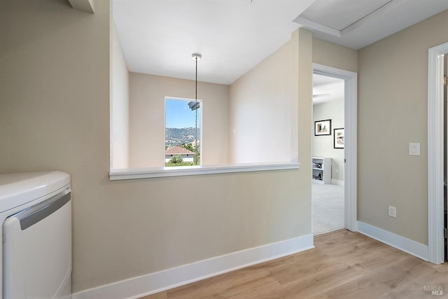 laundry room featuring light hardwood / wood-style floors and washing machine and clothes dryer