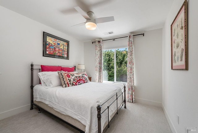 bedroom featuring ceiling fan and light carpet