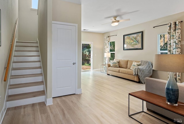 living room with ceiling fan and light hardwood / wood-style floors