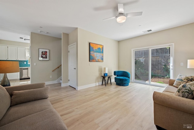 living room featuring light hardwood / wood-style floors and ceiling fan