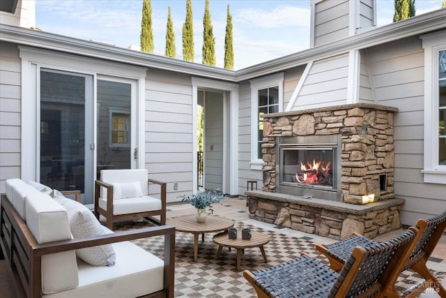 view of patio featuring an outdoor living space with a fireplace