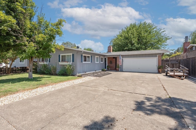 ranch-style home featuring a front yard and a garage