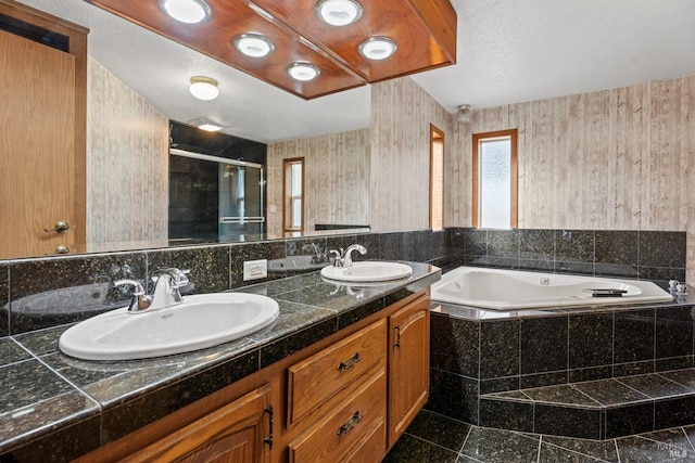 bathroom featuring shower with separate bathtub and vanity