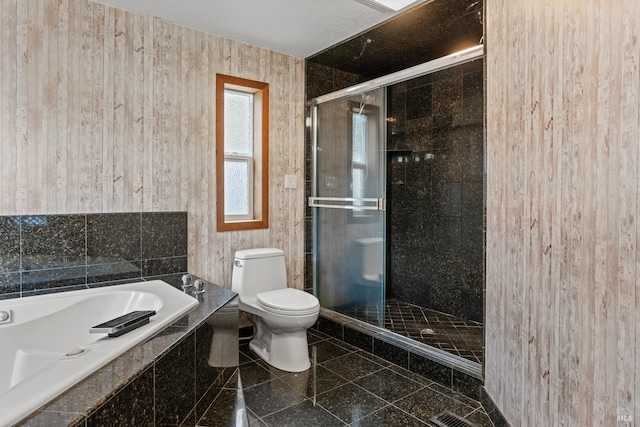 bathroom with shower with separate bathtub and toilet