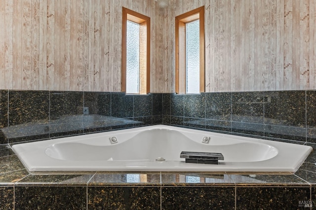 bathroom featuring a relaxing tiled tub