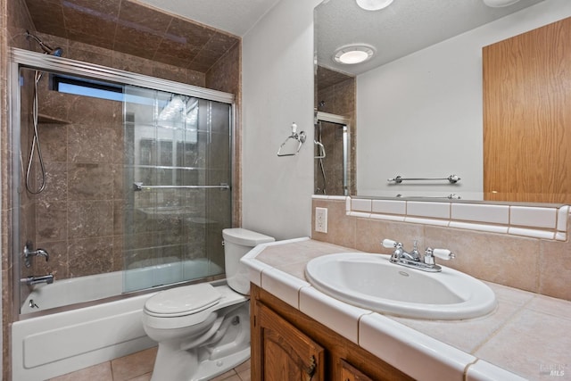 full bathroom with decorative backsplash, vanity, enclosed tub / shower combo, tile patterned flooring, and toilet