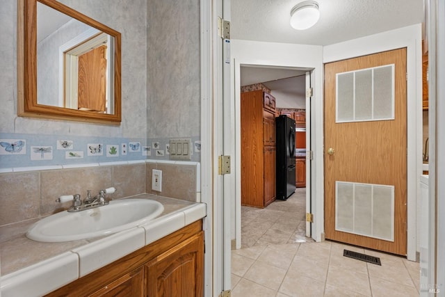 bathroom with tile patterned floors and vanity