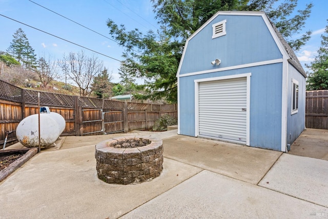 exterior space featuring a fire pit and a shed