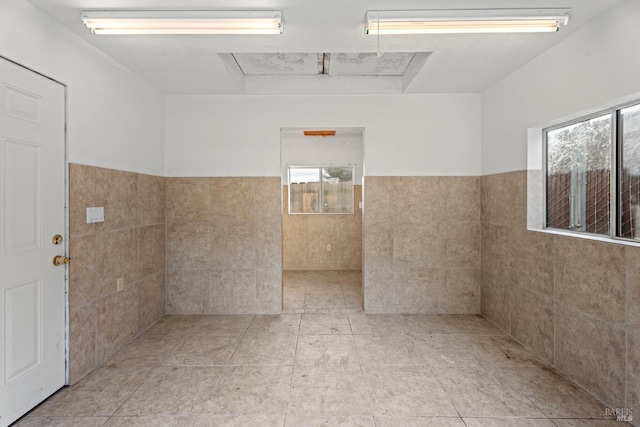 bathroom featuring tile walls