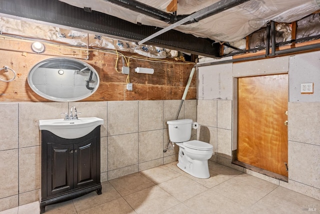 bathroom with tile patterned floors, vanity, tile walls, and toilet