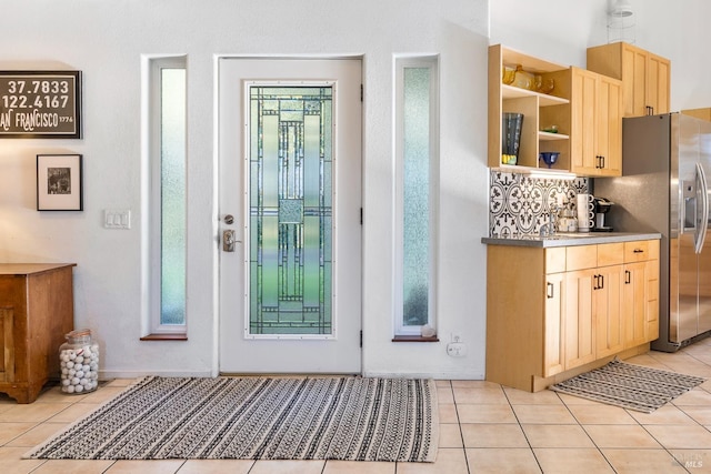 entryway with light tile patterned floors