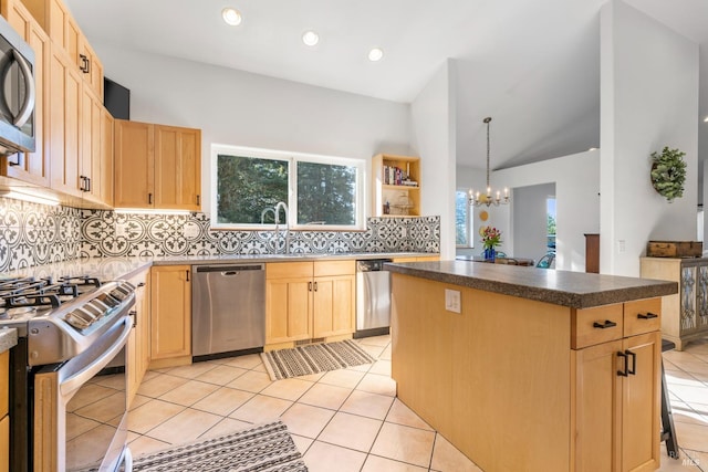 kitchen with light brown cabinets, tasteful backsplash, a notable chandelier, a kitchen island, and appliances with stainless steel finishes