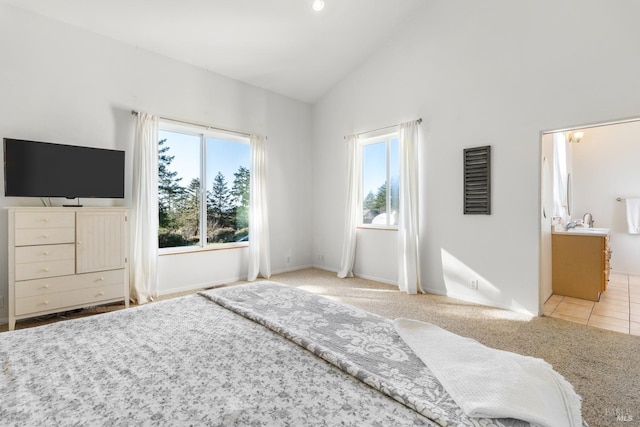 bedroom featuring light colored carpet and high vaulted ceiling