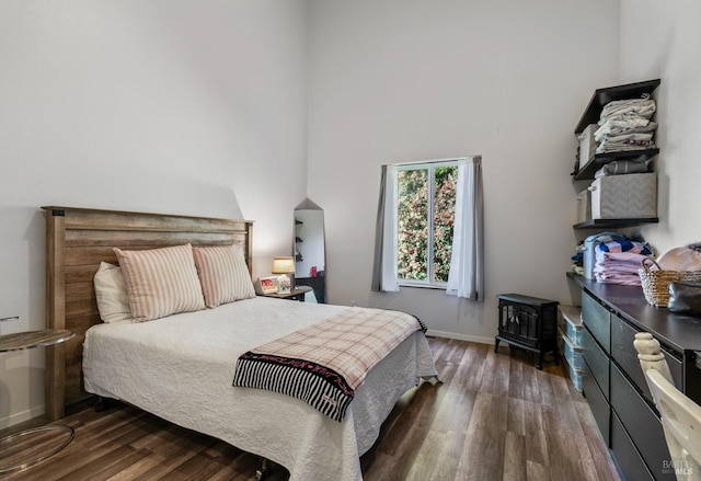 bedroom with dark wood-type flooring