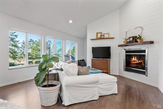 living room with dark hardwood / wood-style floors and vaulted ceiling