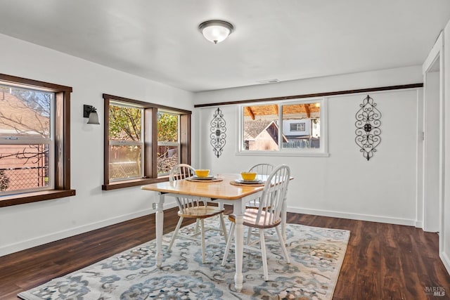 dining space featuring wood finished floors, visible vents, and baseboards