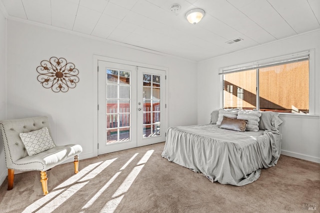 carpeted bedroom with access to exterior, french doors, visible vents, and ornamental molding