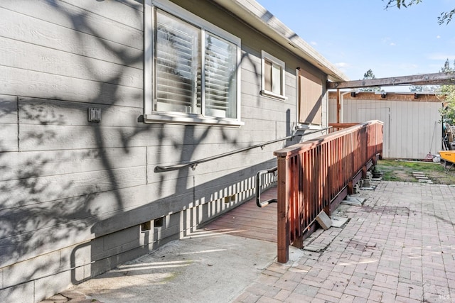 view of side of property featuring fence and a patio