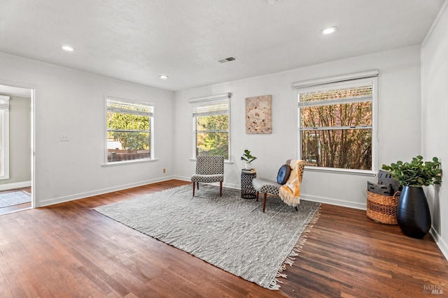 sitting room featuring recessed lighting, wood finished floors, visible vents, baseboards, and crown molding