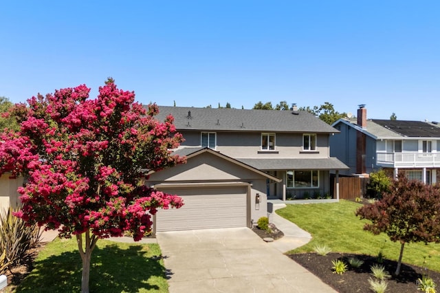 view of front property with a garage and a front lawn