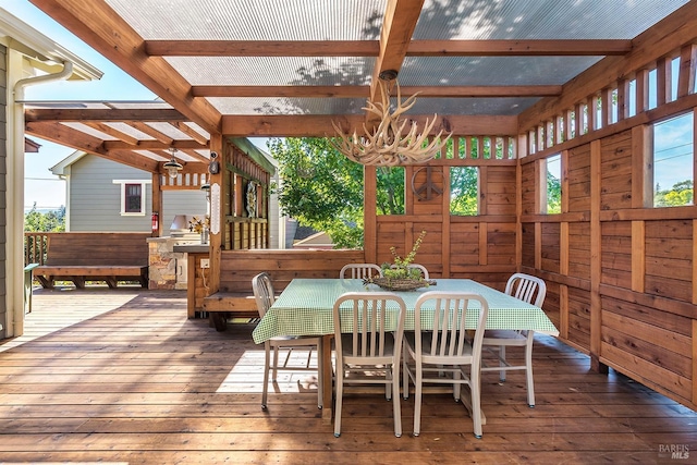 dining room featuring beamed ceiling, wood-type flooring, and a wealth of natural light