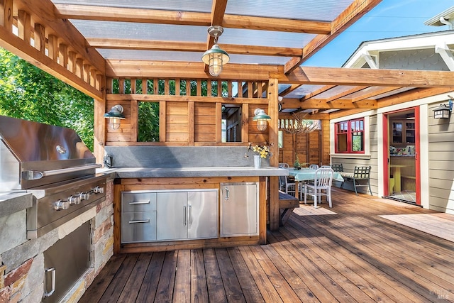 wooden terrace with a grill and an outdoor kitchen