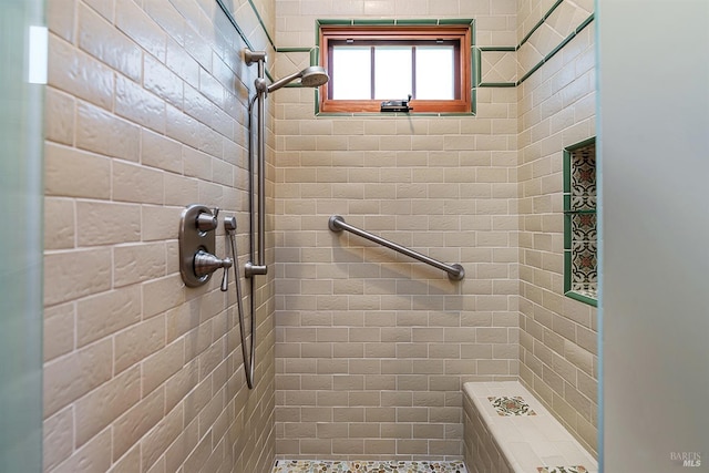 bathroom with a tile shower