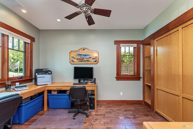 office space with plenty of natural light, dark wood-type flooring, and ceiling fan