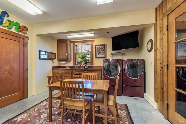 dining room featuring independent washer and dryer and sink