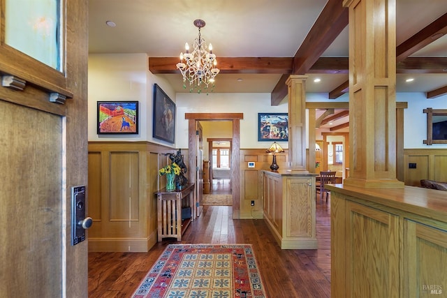 entryway with a chandelier, beam ceiling, decorative columns, and dark hardwood / wood-style floors