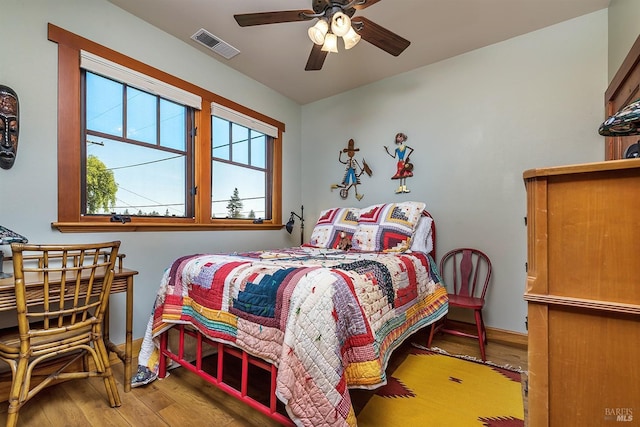 bedroom featuring hardwood / wood-style floors and ceiling fan