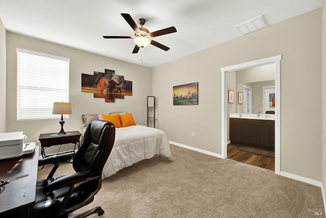 carpeted bedroom with ceiling fan and connected bathroom