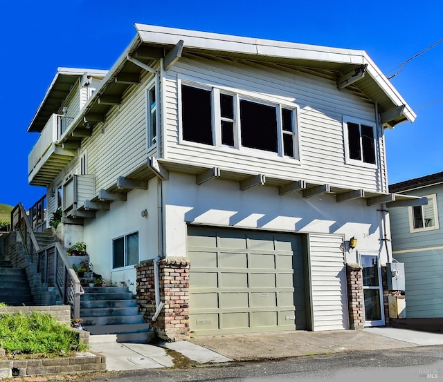 view of front of house featuring stairway and an attached garage