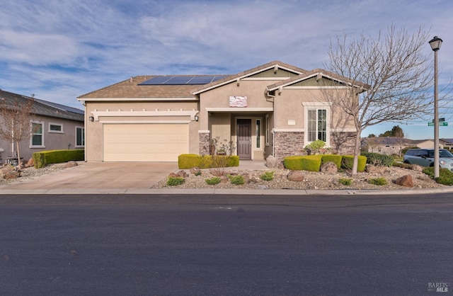 view of front of house with solar panels and a garage