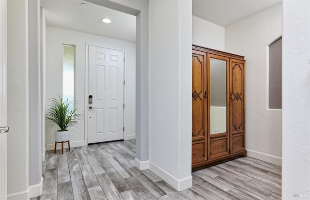 foyer entrance with light hardwood / wood-style flooring