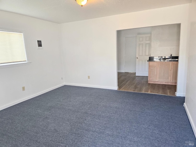 1920 Marin St, Vallejo, CA 94590 - spare room with dark colored carpet, visible vents, and baseboards