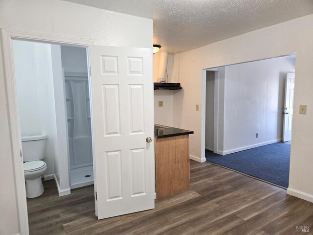 kitchen featuring dark hardwood / wood-style flooring and a textured ceiling