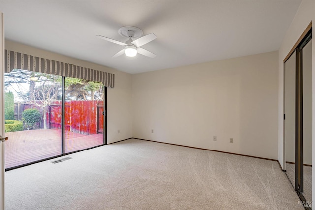 unfurnished bedroom featuring light carpet, access to exterior, and ceiling fan