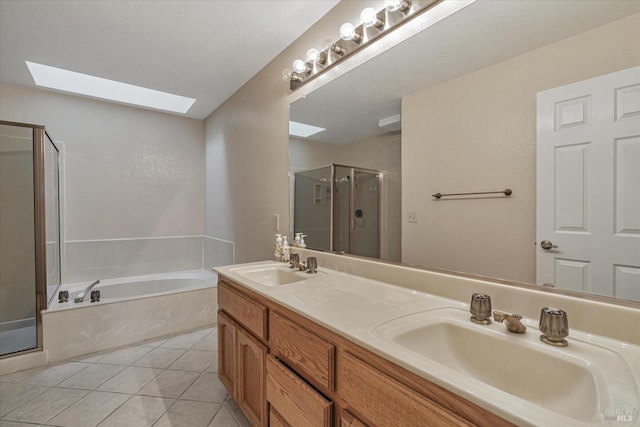 bathroom with plus walk in shower, vanity, a skylight, and tile patterned floors