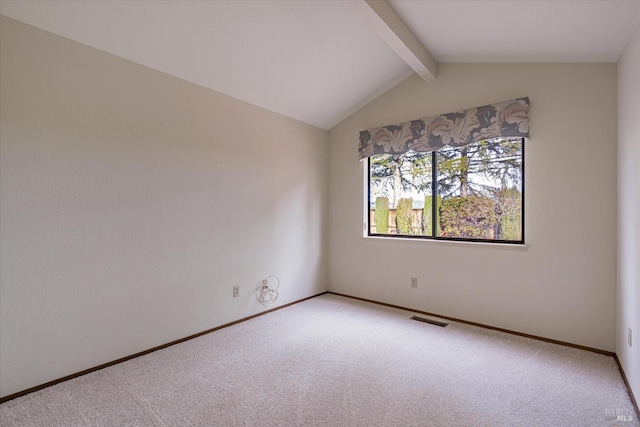 carpeted empty room featuring vaulted ceiling with beams