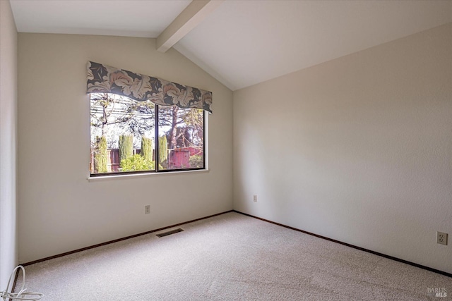 carpeted empty room featuring vaulted ceiling with beams