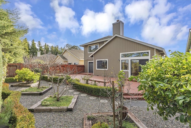 back of property featuring a patio and a wooden deck