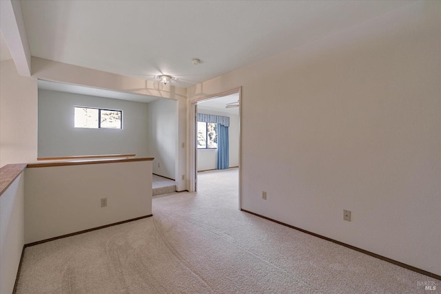 carpeted empty room featuring ceiling fan