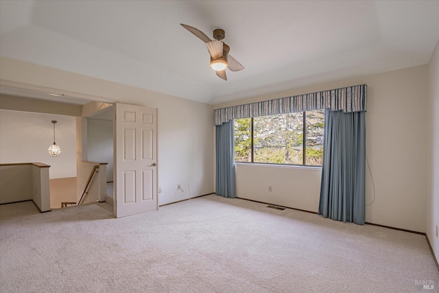 spare room featuring light carpet and ceiling fan