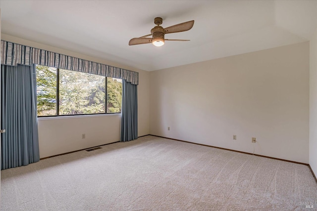 carpeted empty room featuring ceiling fan