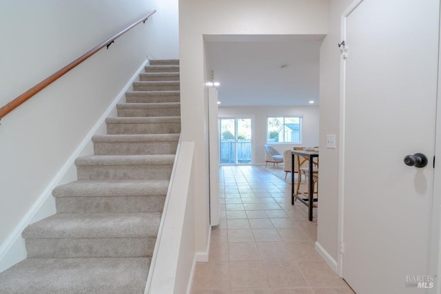 stairs featuring tile patterned flooring